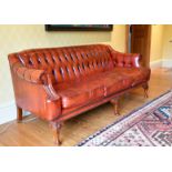 A SUPERB BUTTONED BACK LEATHER SOFA with scroll ends, on mahogany cabriole legs ending in pad