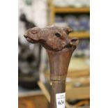 A hardwood walking stick the handle carved as a camels head