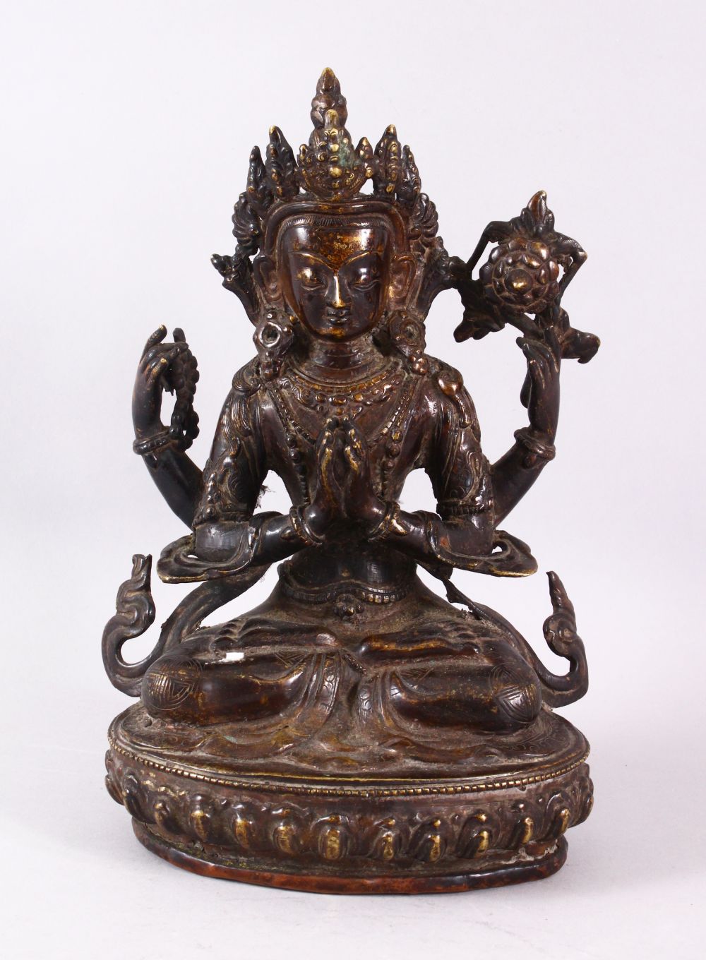 A GOOD TIBETAN BRONZE FIGURE OF A FOUR ARMED DEITY, 25cm high.