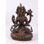 A GOOD TIBETAN BRONZE FIGURE OF A FOUR ARMED DEITY, 25cm high.