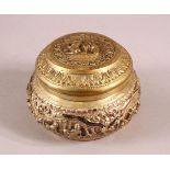 A BURMESE SILVER EMBOSSED BOX & COVER with moulded figural decoration, 11cm