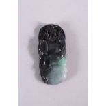 A CHINESE CARVED GREY JADEITE PENDANT, carved as a male figure, 8cm x 4cm.