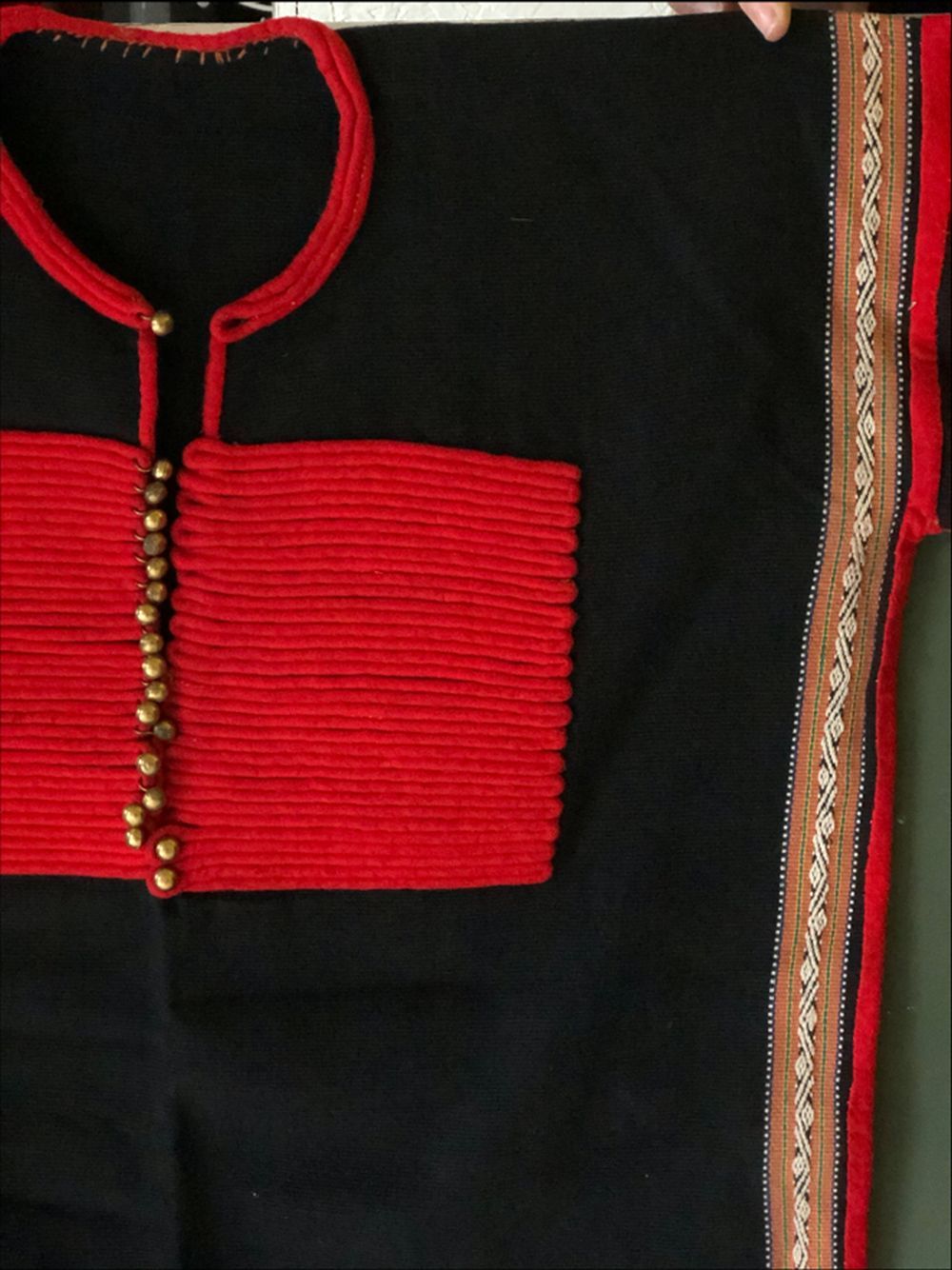 AN UNUSUAL ETHNIC JACKET, 20th Century, possibly Chinese minority people, red embroidered on a black