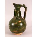 A GREEN GLAZED POSSIBLY UMAYYAD POTTERY EWER, the neck with moulded loop decoration, 22cm high.