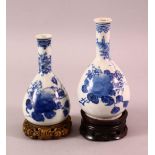 TWO CHINESE BLUE & WHITE PORCELAIN VASES & STANDS, each with floral & fruit decoration, each with