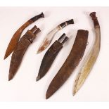 A COLLECTION OF THREE 19TH CENTURY NEPALESE KUKRI DAGGERS in leather scabbards, largest 53cm long.