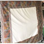 A EUROPEAN WOVEN SILK TURNOVER SHAWL, cream central panel within an embroidered border with