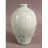 A CHINESE SONG STYLE CARVED CELADON PORCELAIN VASE, decorated with panels of flora, 19.5cm high.