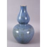 A CHINESE MONOCHROME PALE BLUE GLAZED PORCELAIN GOURD VASE, 20cm high.