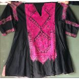 A 20TH CENTURY ETHNIC EMBROIDERED COTTON BLACK AND PINK DRESS, possibly Swat Valley, 48in waist x