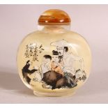 A CHINESE REVERSE PAINTED SNUFF BOTTLE - decorated with figures and moneys in landscapes - with