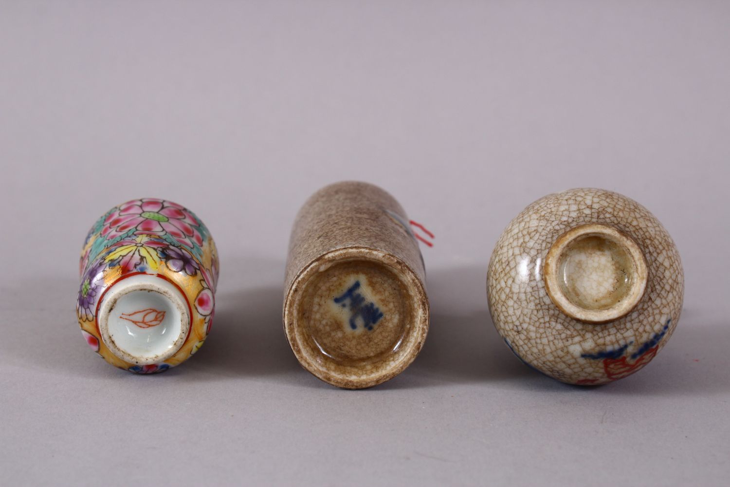 THREE CHINESE PORCELAIN SNUFF BOTTLES, one of floral design, the other two with underglaze blue - Image 3 of 3