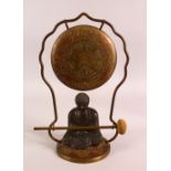 A CHINESE BRONZE BUDDHA ORNAMENT WITH BRASS GONG AND MALLET, 32cm high.