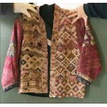 AN ETHNIC EMBROIDERED SHORT JACKET, constructed from laos weavings of geometric design, cotton