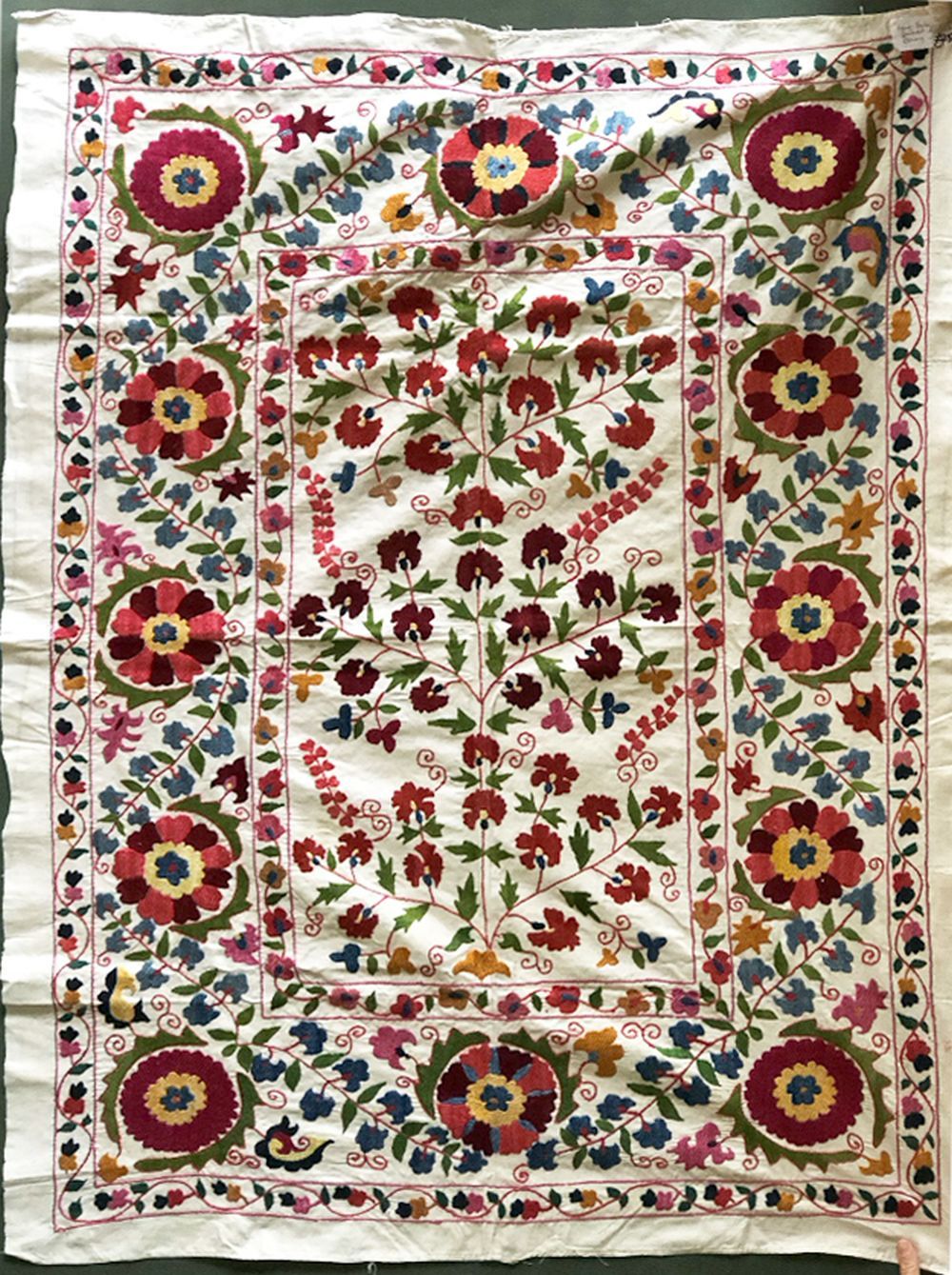 A HAND EMBROIDERED SUSANI WEDDING DOWRI, 20th Century, cream ground with stylised floral embroidery,
