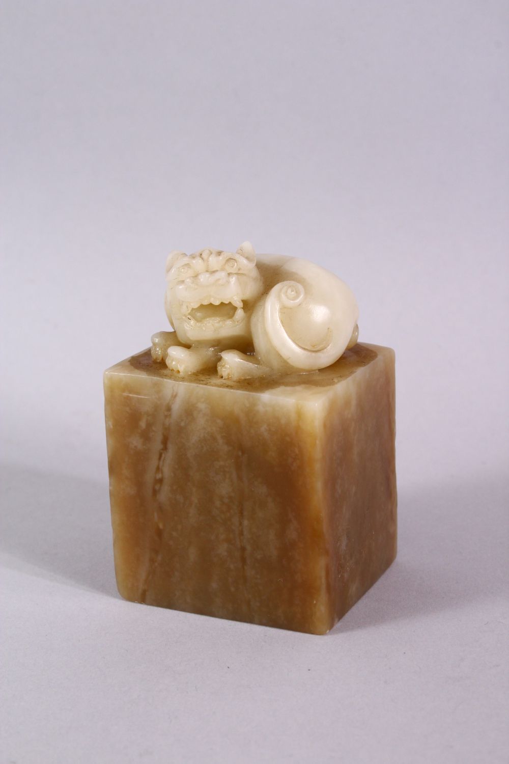 A GOOD CHINESE SOAPSTONE CARVING in the form of a dog of fo, 8cm high.