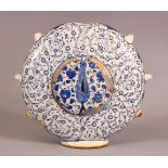 A GOOD TURKISH IZNIK POTTERY WATER FLASK - decorated with scrolling foliage and flora 18cm high .