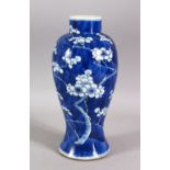 A 19TH CENTURY CHINESE BLUE & WHITE PORCELAIN PRUNUS VASE - decorated with a blue ground and with