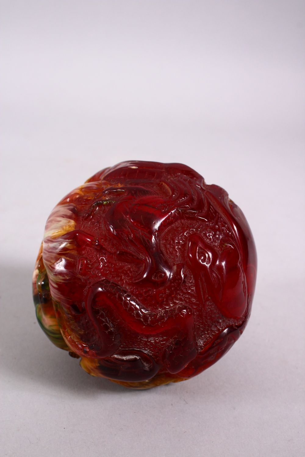 A CHINESE CARVED BAKELITE OR CHERRY AMBER ZODIAC BALL, carved with animals, 9cm diameter. - Image 5 of 8