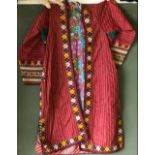 A LONG EMBROIDERED TEKKE COAT, 20th Century, with floral lining and embroidered decoration,