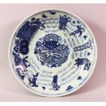 A CHINESE BLUE & WHITE PORCELAIN DISH - decorate with a central dragon and figures outer - 27.5cm