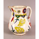 A TURKISH KUTAHYA POTTERY DECORATED JUG - decorated with multi colour glaze to depict flora - 14cm