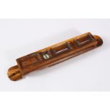 A JERUSALEM OLIVE WOOD SCROLL HOLDER with velum manuscript inside, 21cm long.