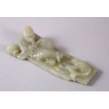 A CHINESE CARVED CELADON JADE FIGURE OF A RECLINED IMMORTAL & FISH, the immortal figure reclined