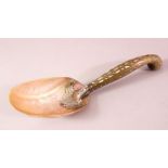 A SOUTH EAST ASIAN SILVER MOUNTED HORN AND MOTHER OF PEARL CEREMONIAL LADLE, 28cm long.