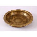 A FINE 18TH CENTURY INDO PERSIAN ENGRAVED BRASS MAGIC BOWL, the interior with calligraphy boteh