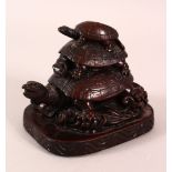 A CHINESE CARVED / MOULDED FIGURE OF THREE TURTLES AMONGST WAVES - 10cm