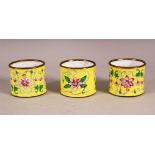 THREE CHINESE YELLOW ENAMEL NAPKIN RING HOLDERS, decorated with formal lotus decoration upon