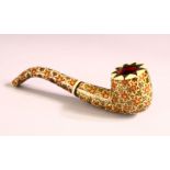 AN INDIAN GILT AND ENAMEL DECORATED BONE PIPE, 13cm long.