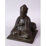 AN 18TH/19TH CENTURY BRONZE SEATED FIGURE OF A SCHOLAR, on a square base, 17cm high.