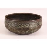 A 16TH CENTURY PERSIAN EARLY SAFAVID ENGRAVED BRONZE BOWL, 23cm diameter.