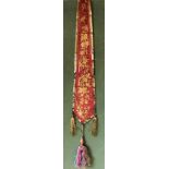 A CHINESE APRON SKIRT PANEL, Circa 1920, red silk with gold thread embroidery, 2ft 10in x 5ins.