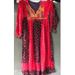 AN AFGAN DRESS, 20th Century, decoratively embroidered front panel and cuffs, waist approx 32in,