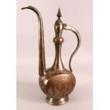 AN ISLAMIC TINNED COPPER EWER, the body with engraved decoration, 39cm high.