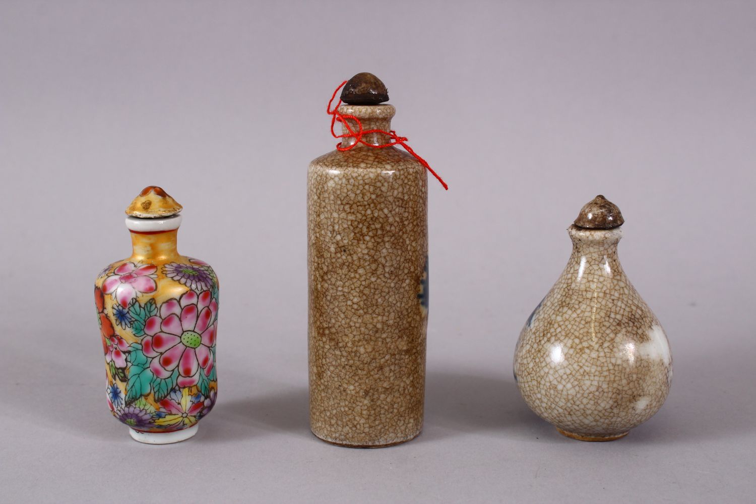 THREE CHINESE PORCELAIN SNUFF BOTTLES, one of floral design, the other two with underglaze blue - Image 2 of 3