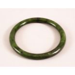 A CHINESE CARVED JADE BANGLE, 7.5cm