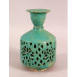 A KASHAN GLAZED TERRACOTTA WATER SPRINKLER, the body with openwork decoration, 15.5cm high,