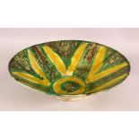 A LARGE NISHAPUR GREEN AND YELLOW GLAZED POTTERY BOWL, 37cm diameter.