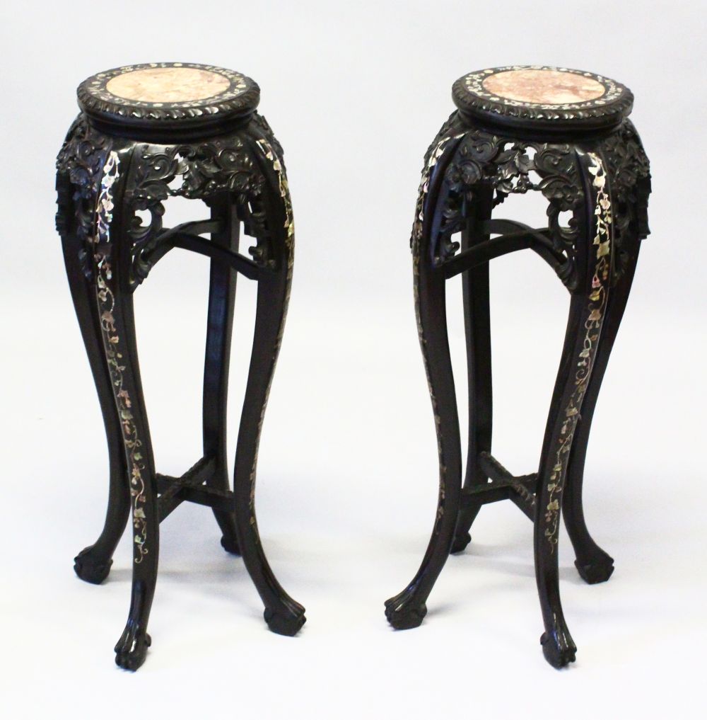 A GOOD PAIR OF LATE 19TH CENTURY CHINESE CARVED HARDWOOD TALL STANDS, each inset with a circular
