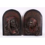 A PAIR OF EGYPTIAN BRONZE RELIEF FIGURAL BUSTS, depicting a prince & princess,each mounted to a