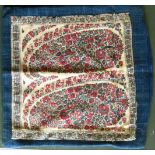 AN EARLY 19TH CENTURY KASHMIR SHAWL FRAGMENT mounted as a cushion cover.