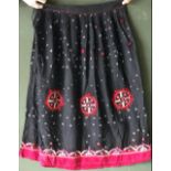 AN INDIAN BLACK SILK SKIRT AND SHAWL SET, each with embroidered and mirrored decoration, skirt waist