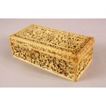 A FINELY CARVED CANTON IVORY CASKET, with well carved panels of scenes depicting figures in