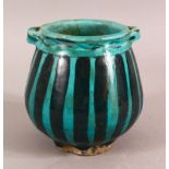 A SMALL RAQQA WARE POSSIBLY 14TH CENTURY TURQUOISE POT, 10cm high, approx. 10cm diameter.