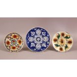 A MIXED LOT OF THREE TURKISH KUTAHYA POTTERY PLATES - one blue & white 18cm & two approx. 14cm