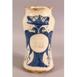 A GLAZED POTTERY BLUE AND WHITE MEDICINE JAR, the body decorated with emblem depicting birds and